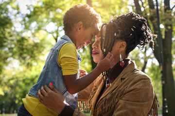 African American single mother in park with her daughter.
