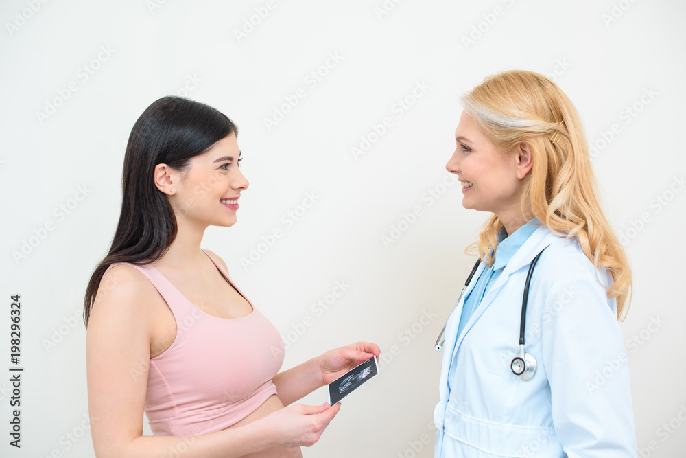 happy obstetrician gynecologist and pregnant woman with ultrasound scan picture happy obstetrician gynecologist and pregnant woman with ultrasound scan picture