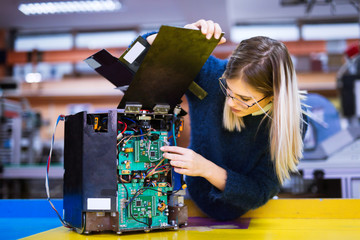 Young student of robotics working on project