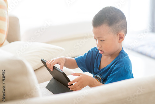 Young child addicted to tablet.