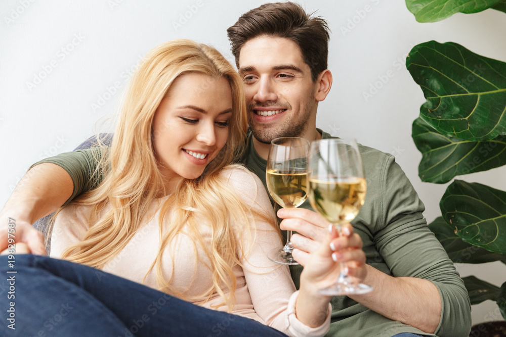 Happy young loving couple drinking alcohol white wine champagne. Happy young loving couple drinking alcohol white wine champagne.