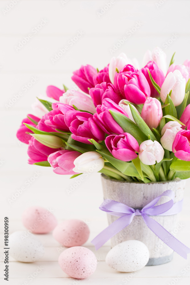Obraz premium Pink tulip on the white background. Easter background