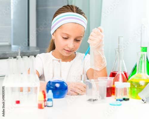 little girl with flasks for chemistry