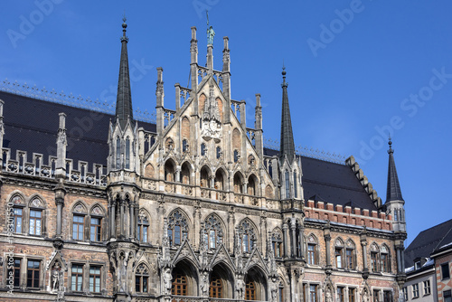 Germany, Bavaria, Munich, Marienplatz: Detail of right part of the famous facade of the New Town Hall (Neues Rathaus) in the German city center of the Bavarian capital with blue sky in the background.