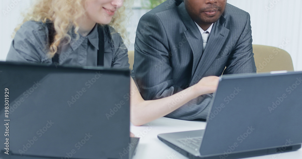 younger employees discussing business issues in office younger employees discussing business issues in office