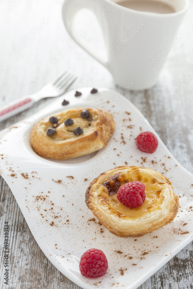 Cream cake and puff pastry with raspberries and chocolate.