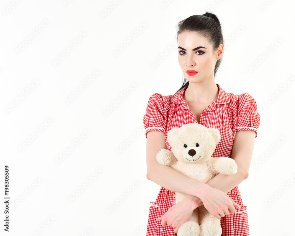 Beautiful girl holding a teddy bear.