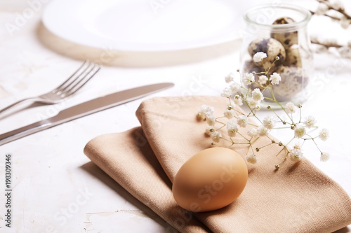 Easter laying table appointments  table setting options. Silverware  tableware items with festive decoration. Fork  knife and flowers. Happy easter holiday.