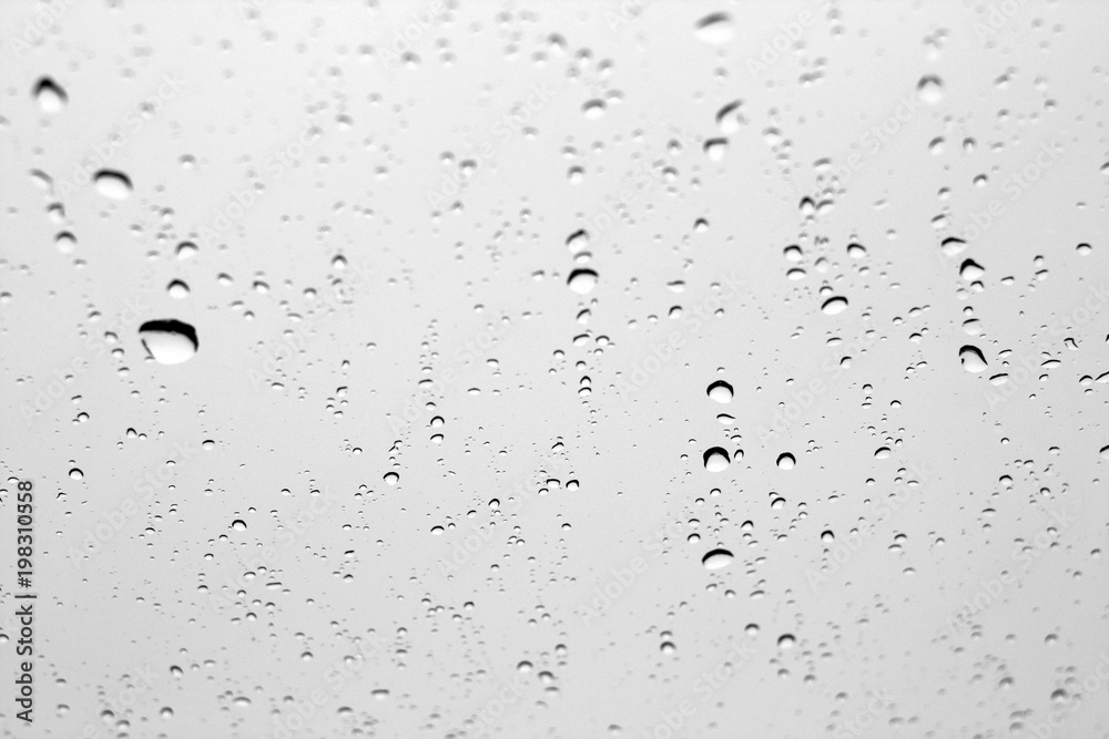 Rain drops on car window in black and white. Rain drops on car window in black and white.