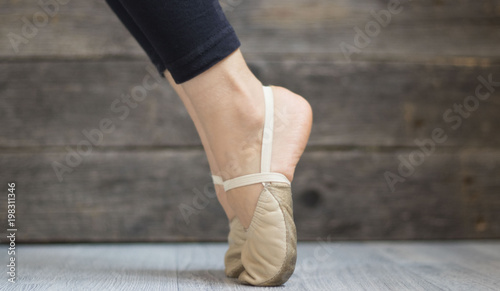 gymnasts feet in the toes on wooden background
