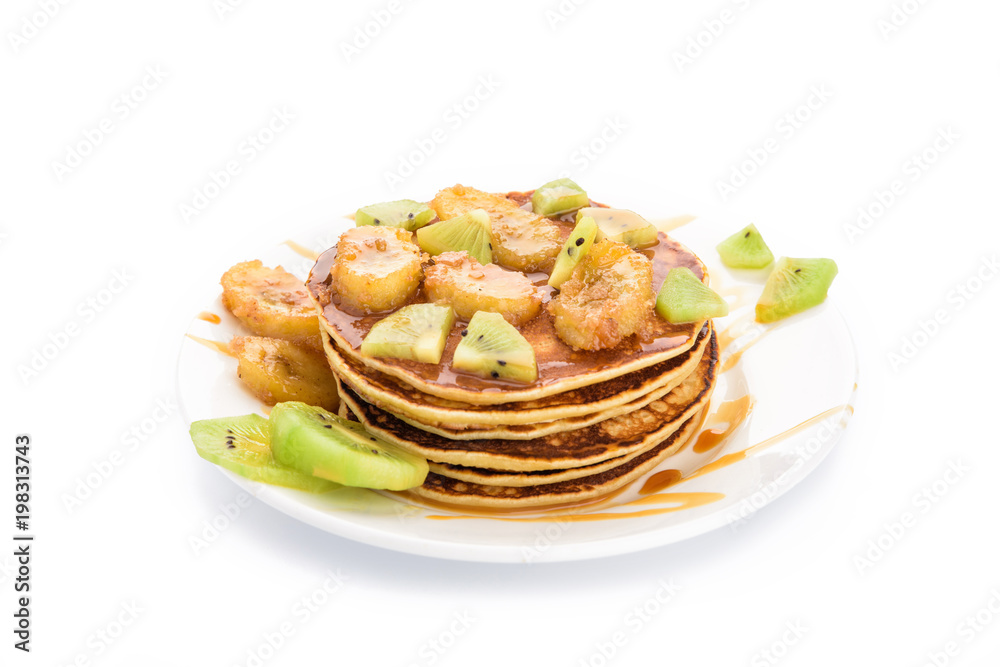 Stack of pancakes isolated on white background. Delicious breakfast with a grilled bananas and a caramel, kiwi slices. Top view, flat lay Stack of pancakes isolated on white background. Delicious breakfast with a grilled bananas and a caramel, kiwi slices. Top view, flat lay