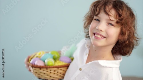 Cute little boy with an Easter basket smiling looking at the camera photo
