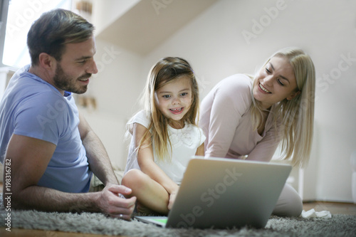Family using laptop.