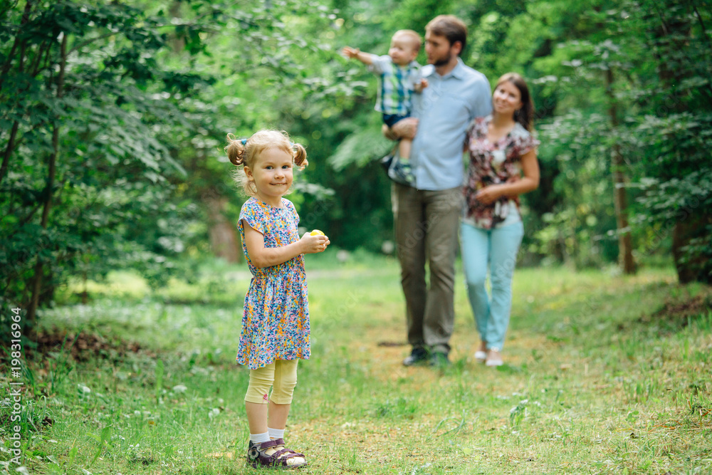 Young happy family walking in the park.