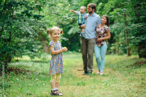 Young happy family walking in the park.