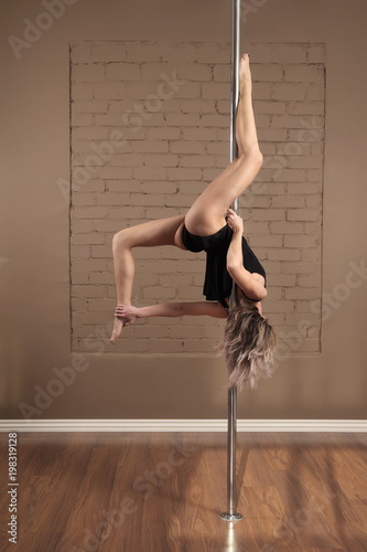 flexible girl practicing on the pylon