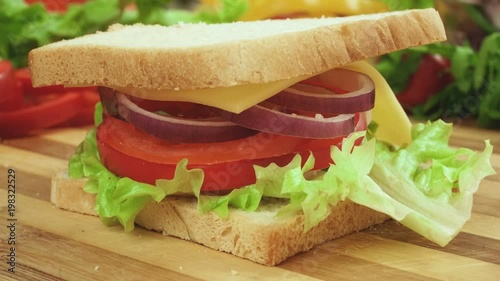 Stop motion video of making sandwich with tomato, ham, bow, cheese and salad