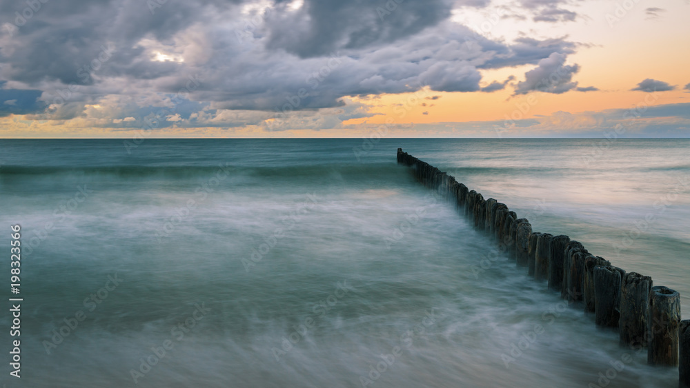 Wooden breakwater on the Baltic sea at dusk