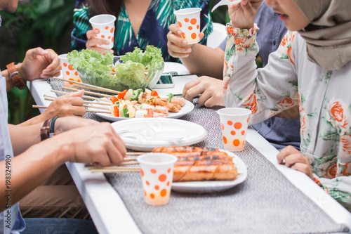 friends enjoying meal at outdoor party