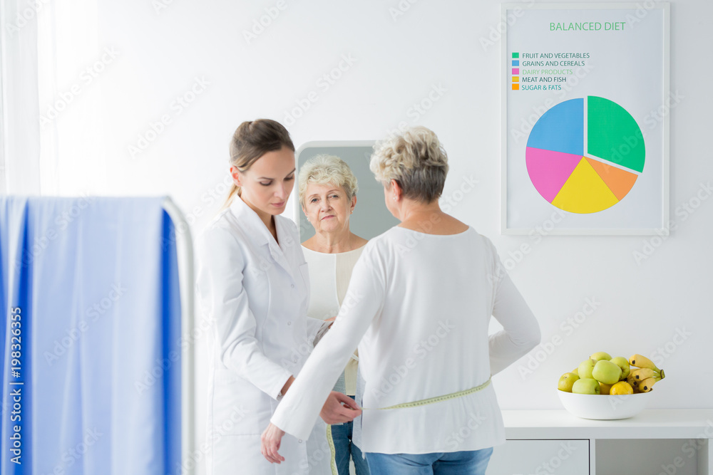 Fototapeta premium Dietician measuring patient's body circuit