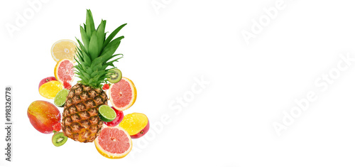 Fresh fruits  pineapple surrounded with grapefruit  lime  kiwi  mango  strawberries in water splash  isolated on white background with free space