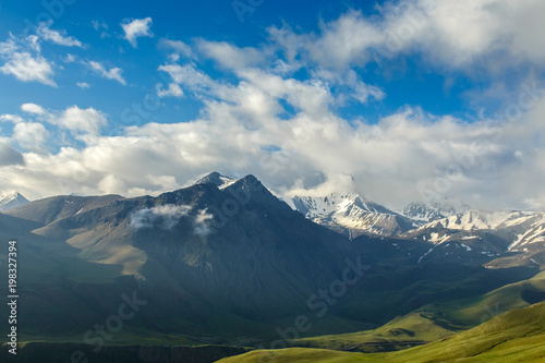 Mountain landscape and rain clouds among the snow-capped peaks