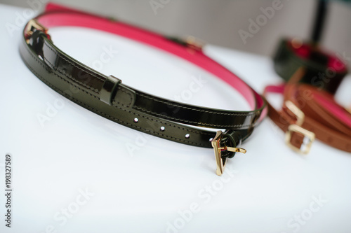 fashionable women's leather belt on the shelf. sale of leather goods