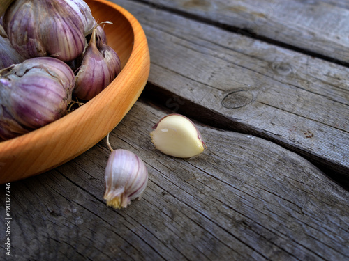 Fresh garlic on a wooden plate