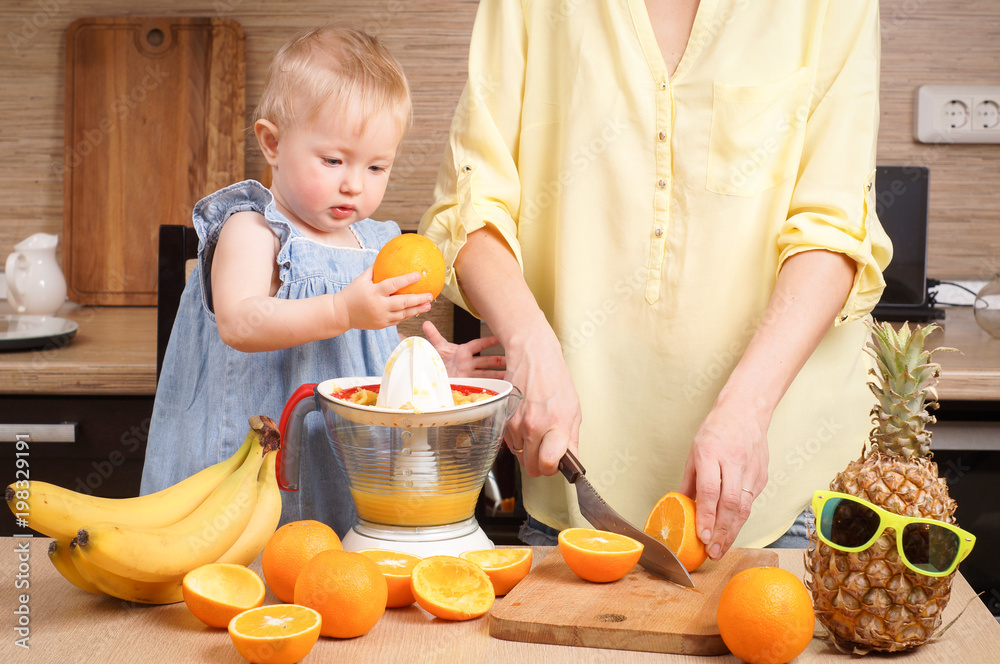 Healthy food for children: Mom and daughter make fresh orange juice Healthy food for children: Mom and daughter make fresh orange juice