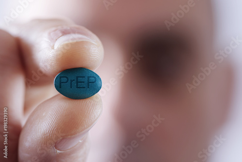 young man with a PrEP pill photo