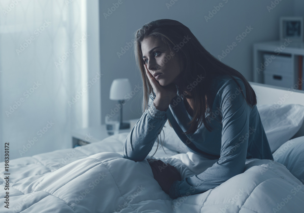 Depressed woman awake in the night Depressed woman awake in the night