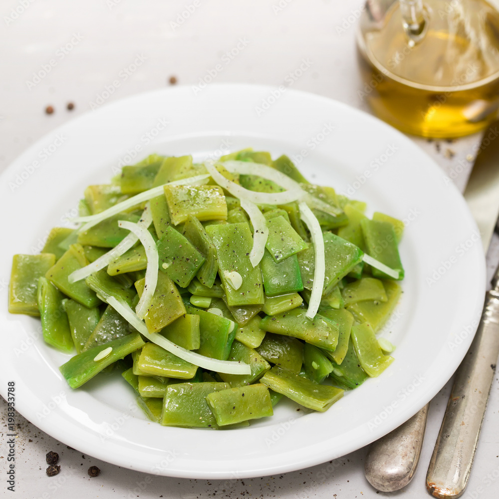 boiled green beans with onion on white plate boiled green beans with onion on white plate