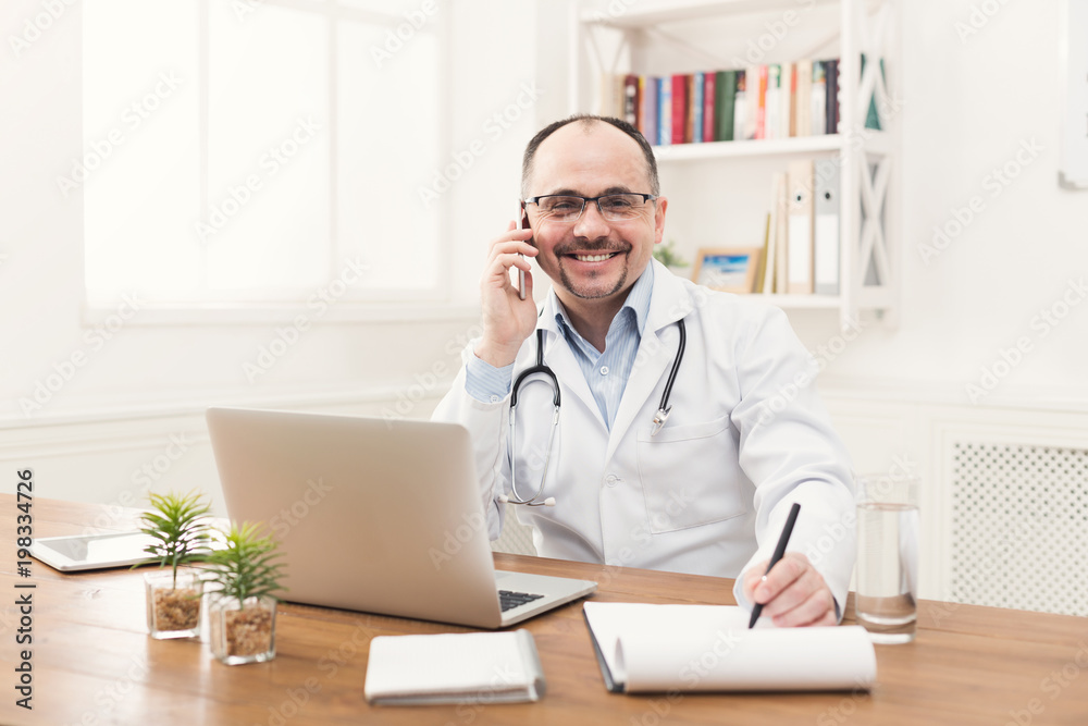 Happy doctor talking on phone with his patient Happy doctor talking on phone with his patient