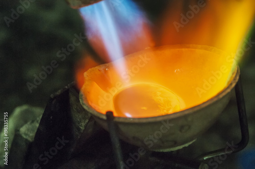Craft jewelery making with professional tools. Macro shot. A handmade jeweler process, manufacture of jewellery. Melting metal