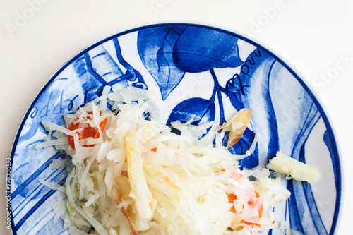 Half a plate with stewed cabbage, carrots and pieces of potatoes. Candid, copy space. photo