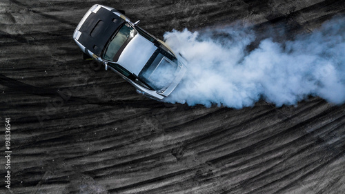 Aerial top view drifting car, Aerial view professional acceleration driver drifting car on asphalt race track, Extreme automobile sport for adrenaline.