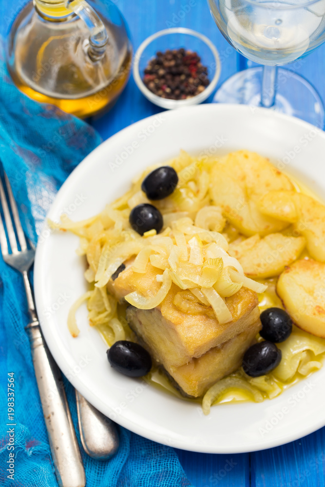 fried cod fish with onion and potato on white plate fried cod fish with onion and potato on white plate
