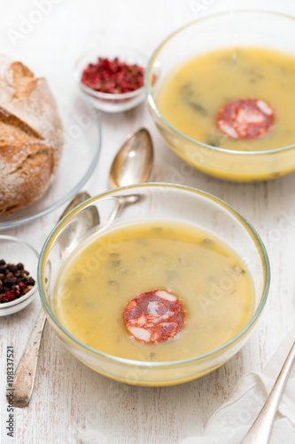 soup with spinach and smoked sausage in small bowls