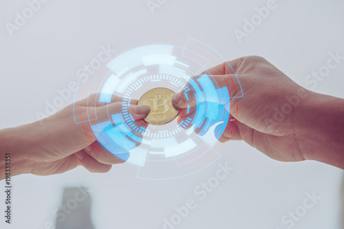 Businessman gives the bitcoin man.selective focus.Businessman giving golden bitcoin to another man. two hands exchanging cryptocurrency.