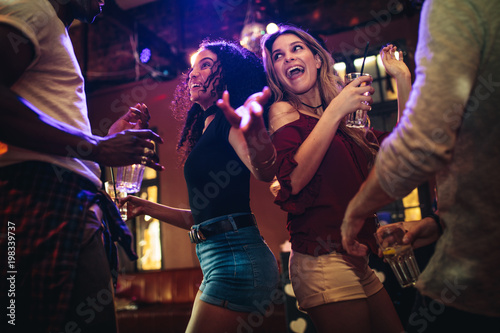 Friends dancing and partying at nightclub