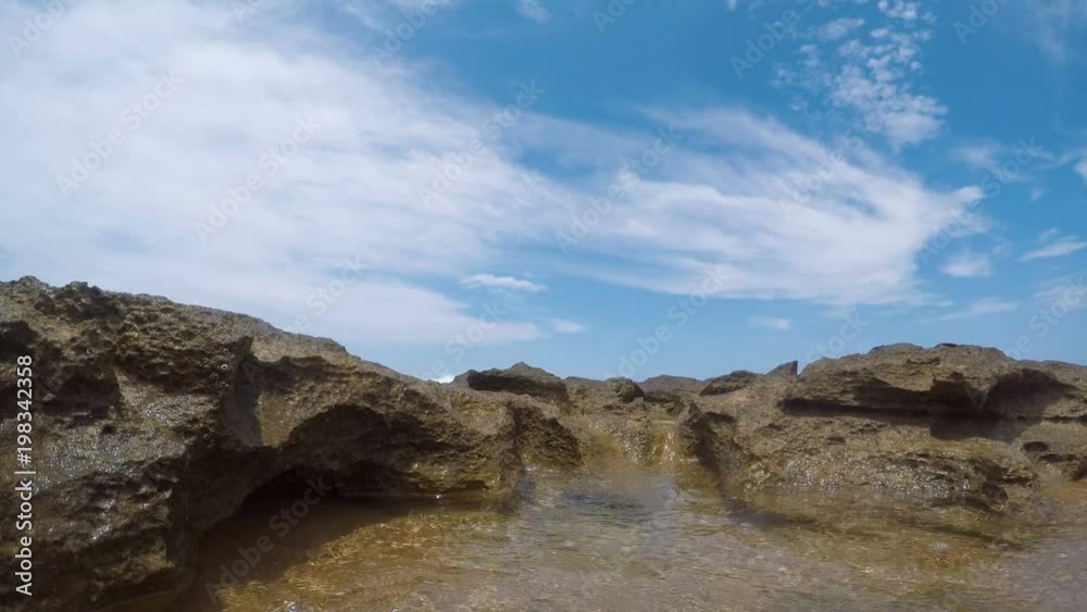 Detail of rocks in a n ocean reef with wave washing over camera Detail of rocks in a n ocean reef with wave washing over camera