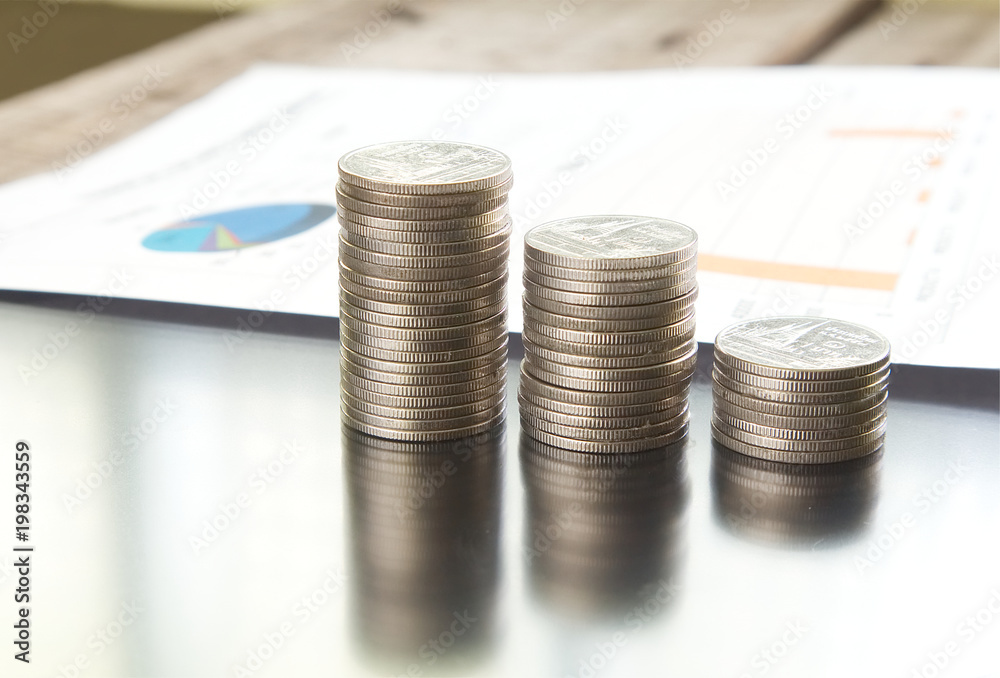 Close-up stack of money with paper document on background Close-up stack of money with paper document on background
