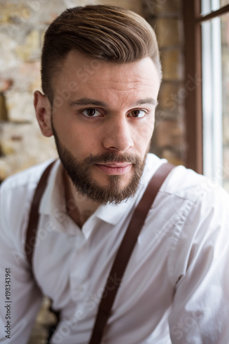 Happy portrait of smiling handsome bearded man in white shirt with very good mood.