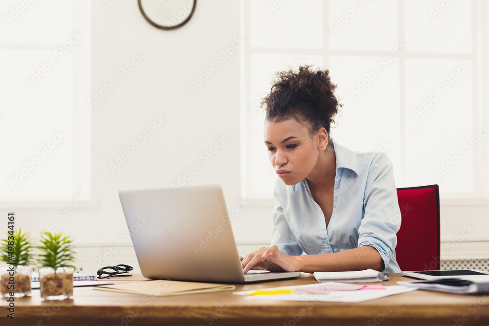 Serious business woman working on laptop at office Serious business woman working on laptop at office