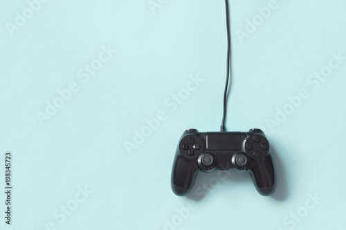 Gamepad connected wire from the game console on blue background.