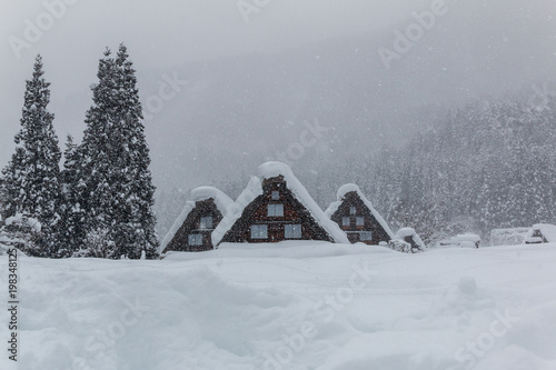 Gassho  houses  in Shirakawago village with snow covered ground ,blue sky and mountains background at winter in snowy day ,Gifu,Japan. © NEPTUNESTOCK