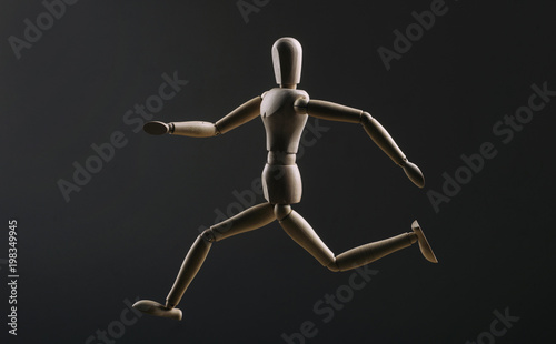 Wooden figure Manikin running  photo