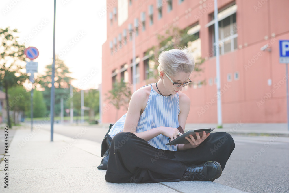young woman outdoor using tablet - remote working, small business, technology young woman outdoor using tablet - remote working, small business, technology