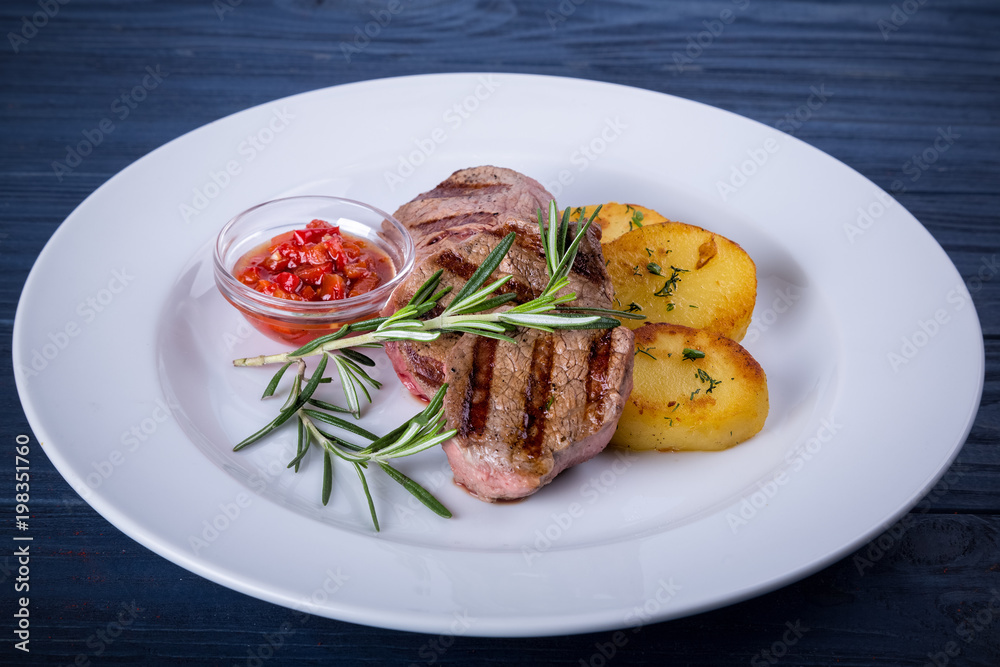 Assorted grilled meats and vegetables on a white wooden table. Healthy eating. View from above Assorted grilled meats and vegetables on a white wooden table. Healthy eating. View from above