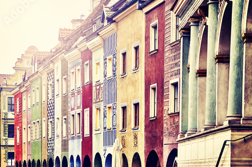 Merchant houses facades in the Poznan Old Market Square, color toned picture, Poland.